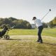 man swinging golf club