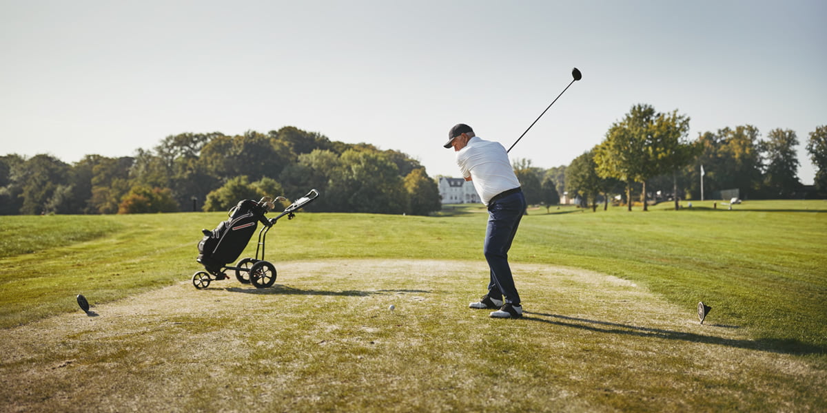 man swinging golf club